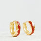 Exquisite gold-plated huggie hoop earrings adorned with vibrant red enamel, perfect for adding a touch of elegance.