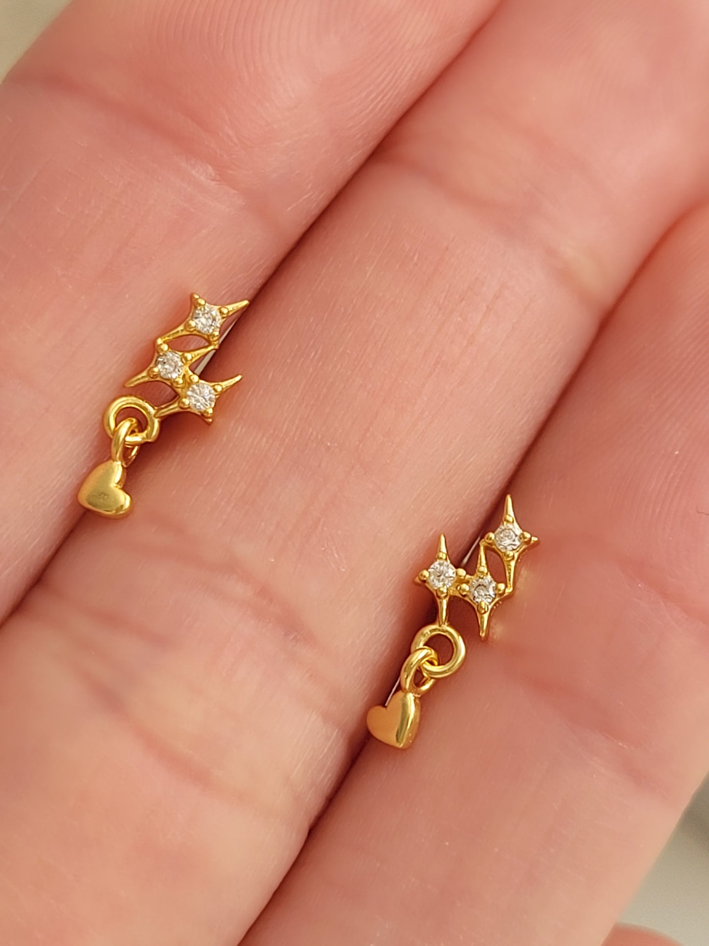 Dainty gold star stud earrings with heart charm crafted in gold plated sterling silver with sparkling cz diamond. Perfect gift for birthdays or anniversaries.