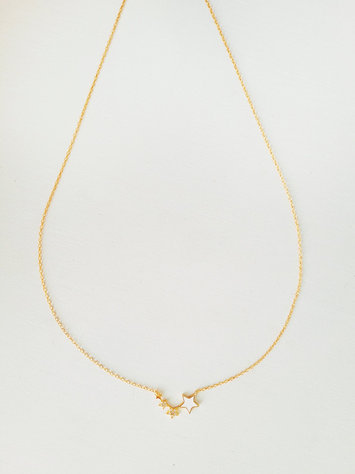 Displaying the elegant gold plated star necklace.