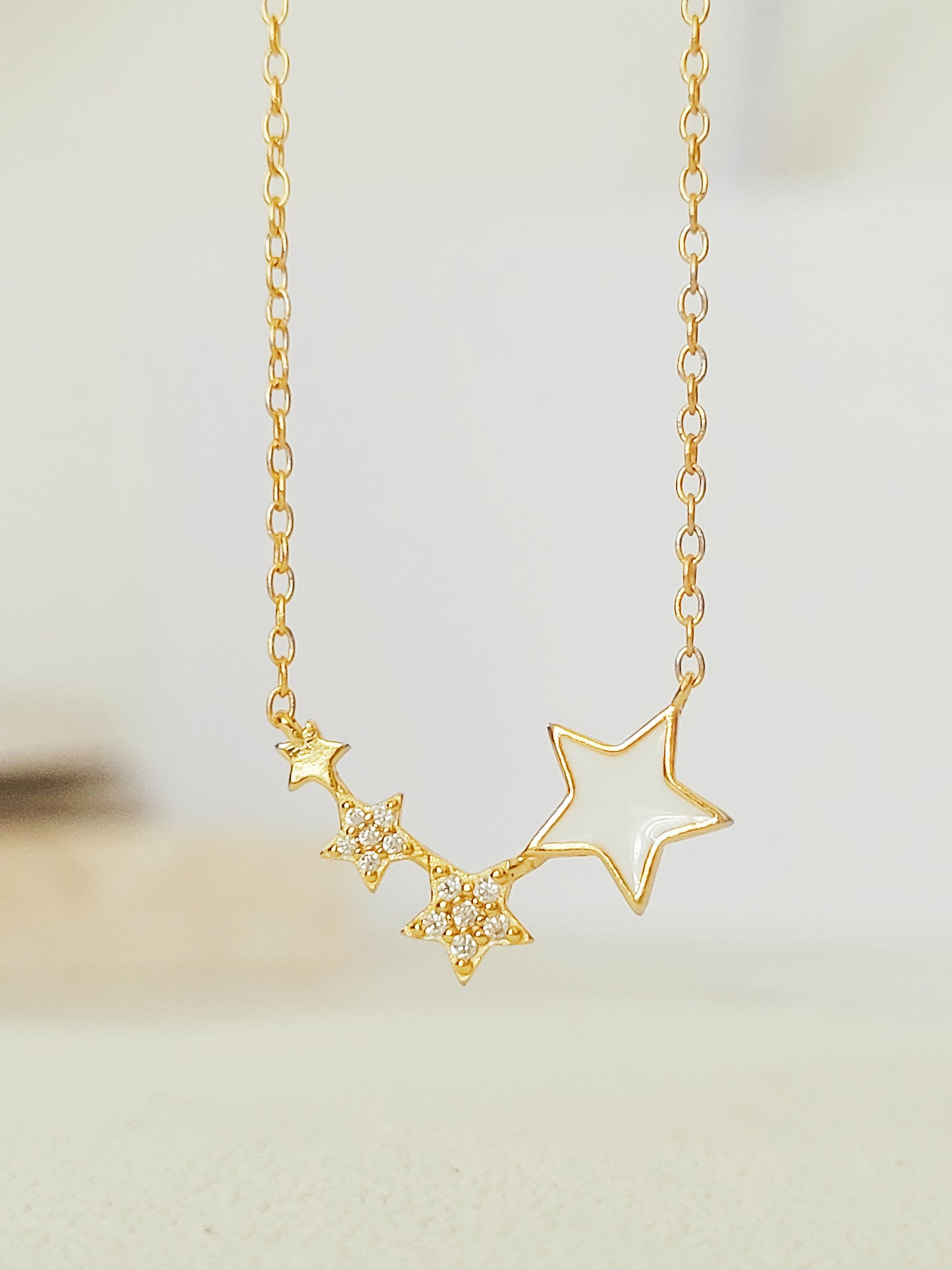 Close-up of the Stars Pendant Necklace showcasing the detailed craftmanship. 