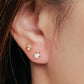 A model wearing a dainty Crown Opal Stud Earrings with screw back closure for comfortable daily wear. Crafted in sterling silver with 18k gold plated and adorned with diamond accents.