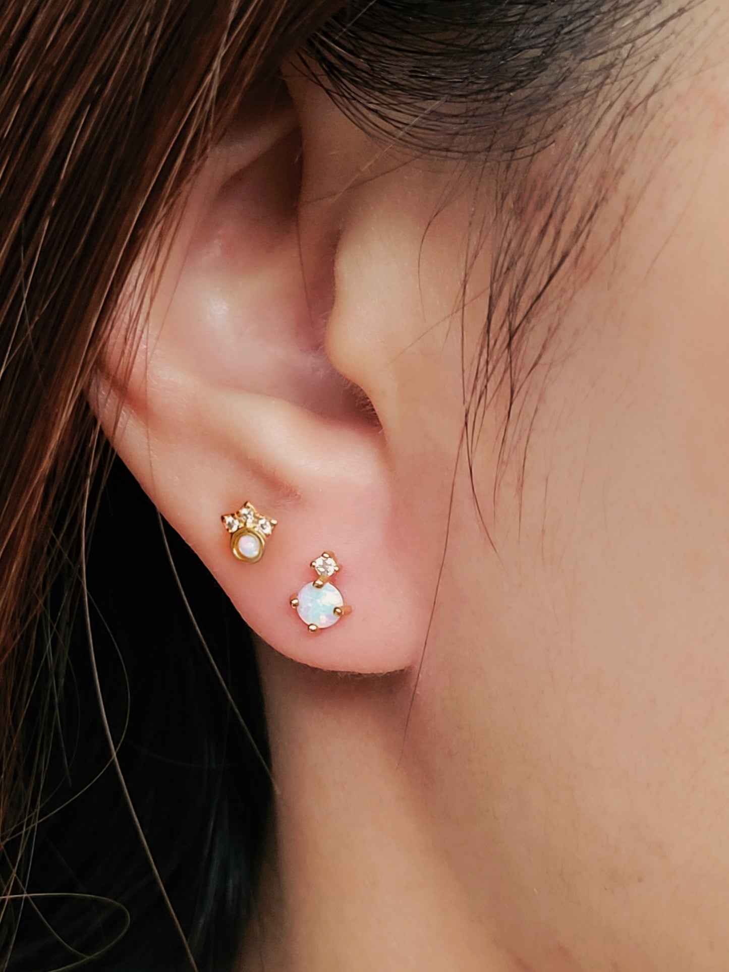 A model wearing a dainty Crown Opal Stud Earrings with screw back closure for comfortable daily wear. Crafted in sterling silver with 18k gold plated and adorned with diamond accents.