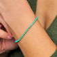 Close up of a woman's wrist wearing a Gold Turquoise beaded bracelet. Crafted in high quality natural turquoise gemstone intersecting with gold vermeil beads.