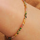 Close-up of a boho-chic beaded bracelet featuring natural tourmaline and gold plated beads. Perfect gift for her.