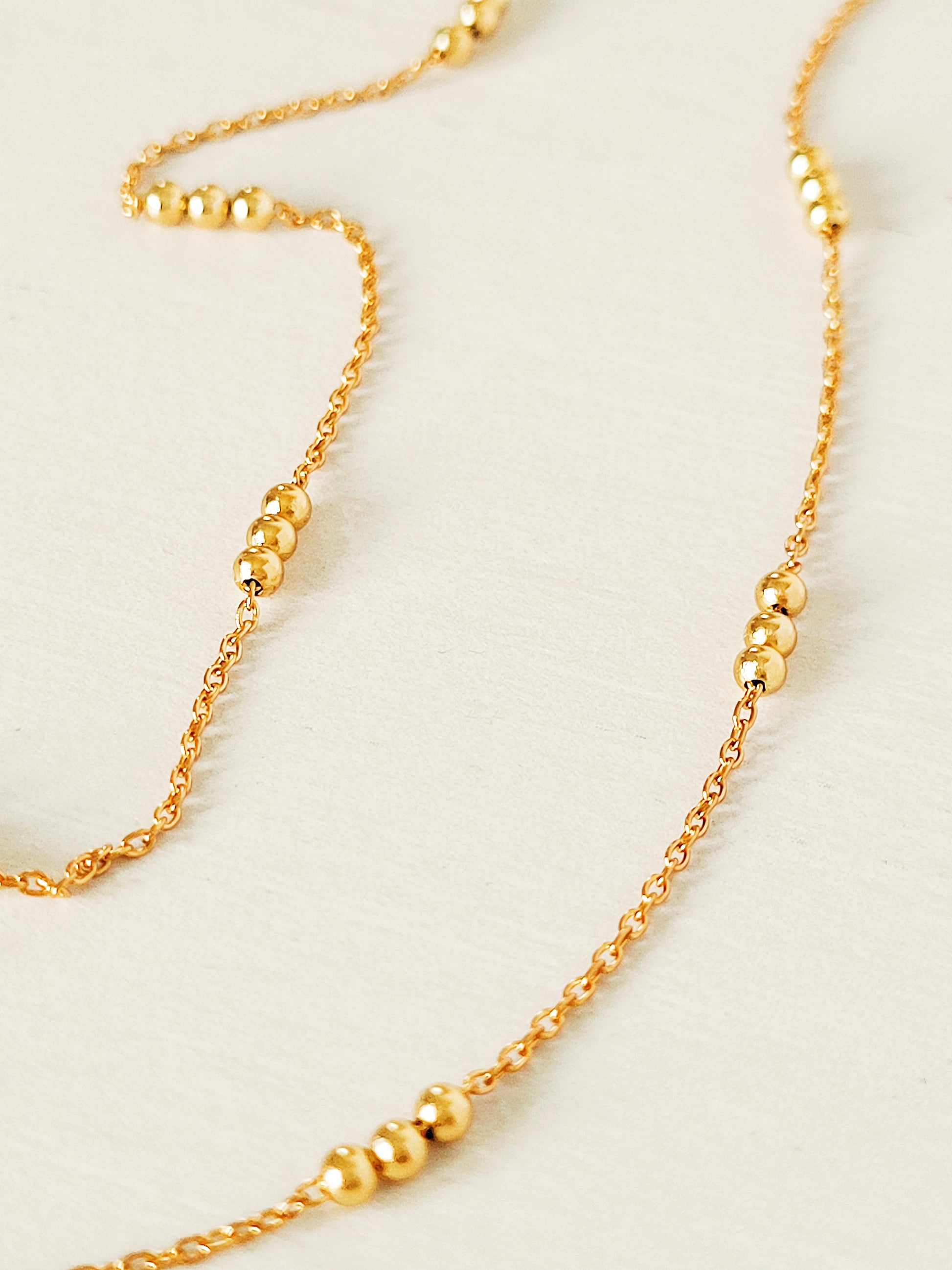 Elegant 18ct gold vermeil Triple Ball Necklace, crafted with a delicate gold chain and three polished beads. The rich gold hue of the vermeil finish provides a luxurious yet versatile piece.