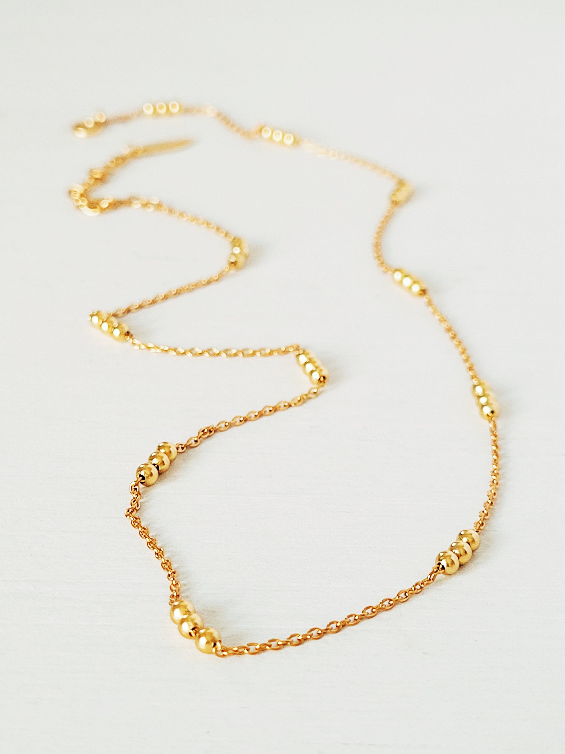 Elegant 18ct gold vermeil Triple Ball Necklace, crafted with a delicate gold chain and three polished beads. The rich gold hue of the vermeil finish provides a luxurious yet versatile piece.