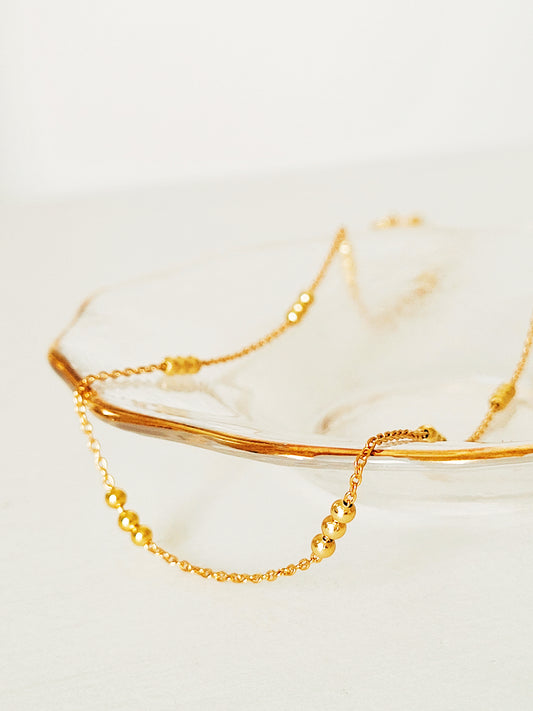 Elegant 18ct gold vermeil Triple Ball Necklace, crafted with a delicate gold chain and three polished beads. The rich gold hue of the vermeil finish provides a luxurious yet versatile piece.