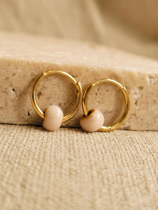 A pair of minimalist gold huggie earrings with white enamel charm, simple and cute earrings. Best gift for teen girl.