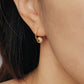 Close-up of peach white Enamel Huggie Earrings, showcasing its fun and minimalist design for a cute and playful look.