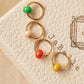 Set of four colors minimal drop hoop earrings featuring colorful enamel beads. 