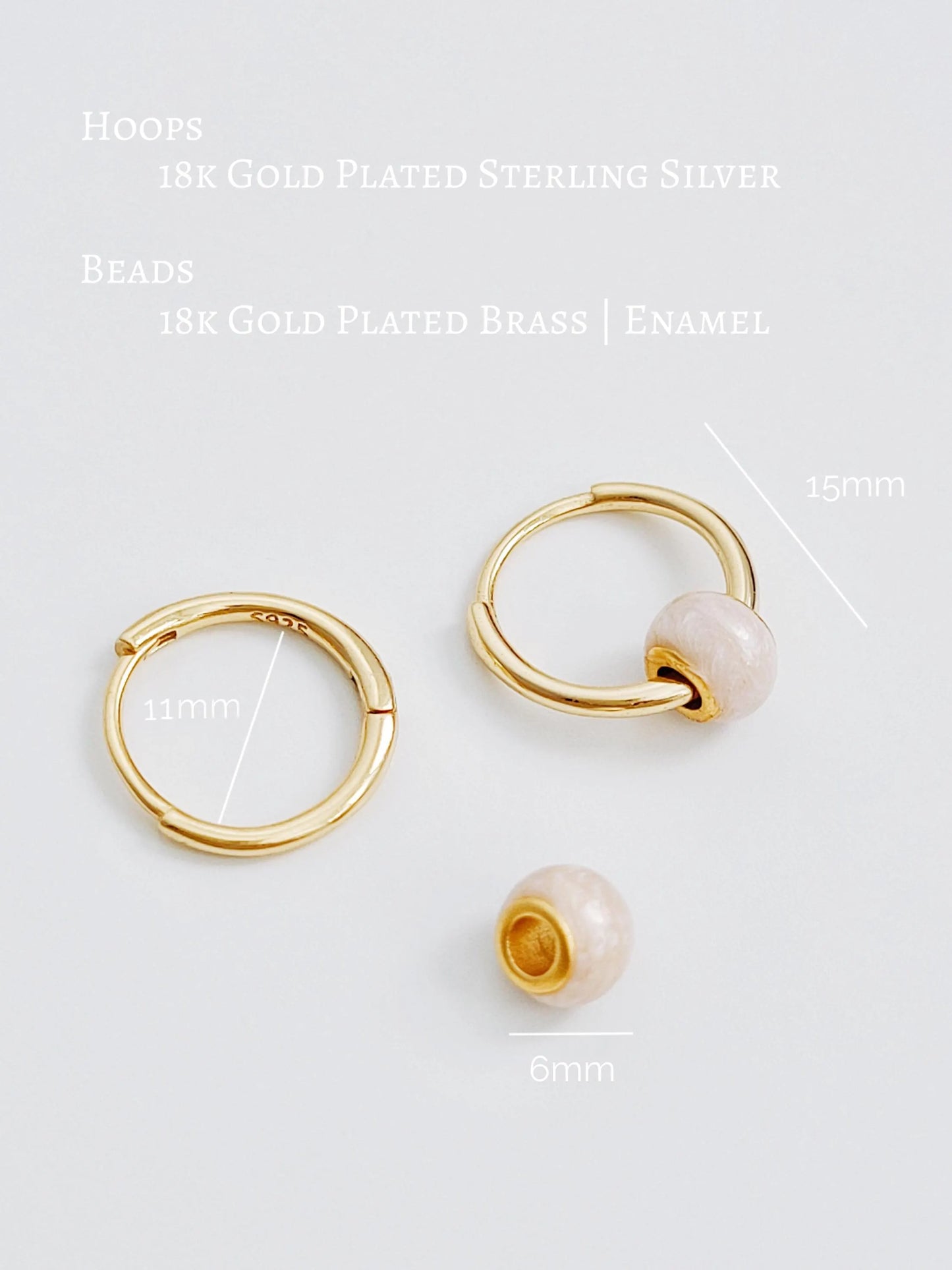 Gold hoop earrings and a gold bead with measurements on a white background