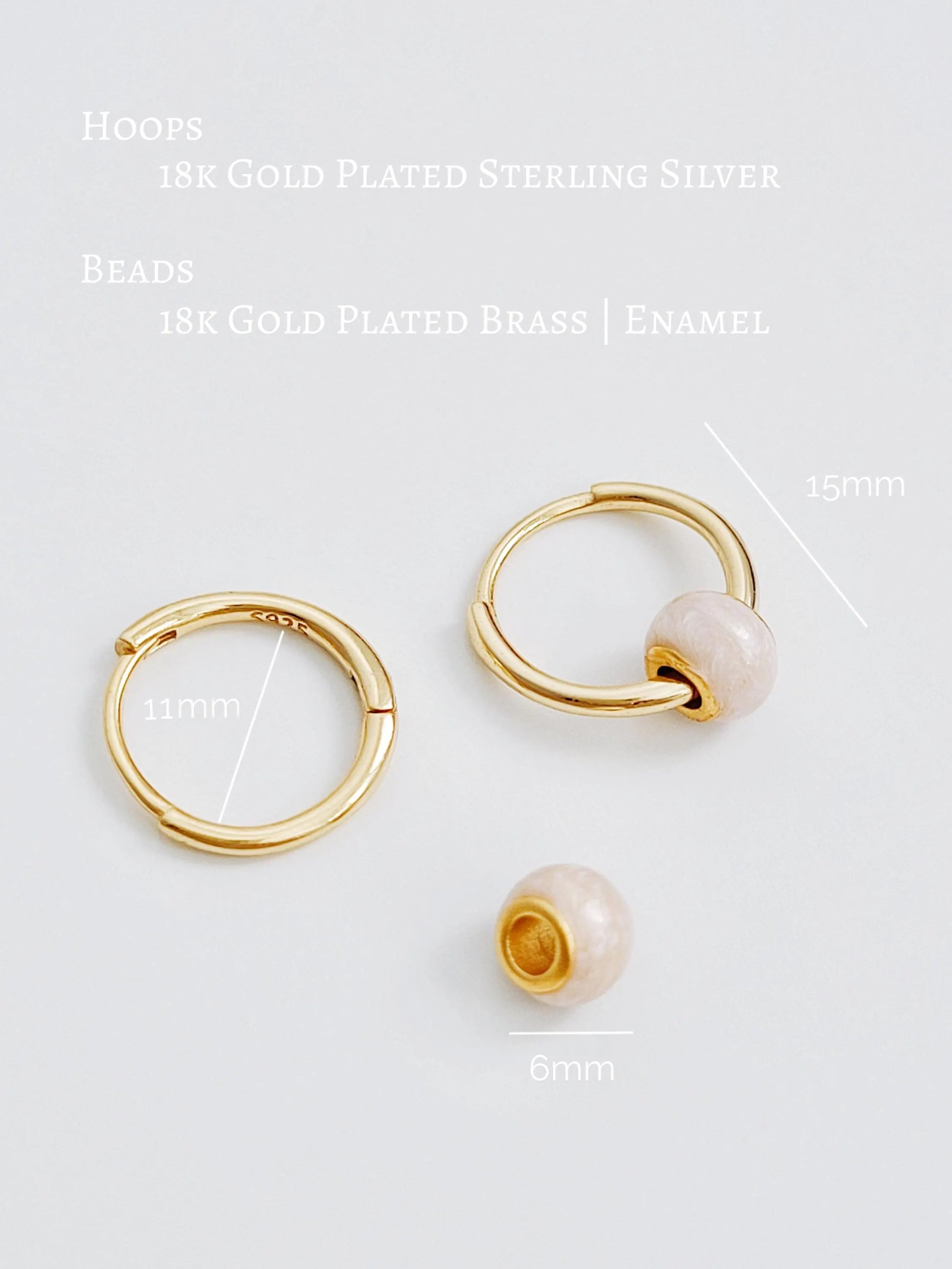 Gold hoop earrings and a gold bead with measurements on a white background