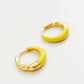 Pair of yellow enamel gold hoop earrings on a white background