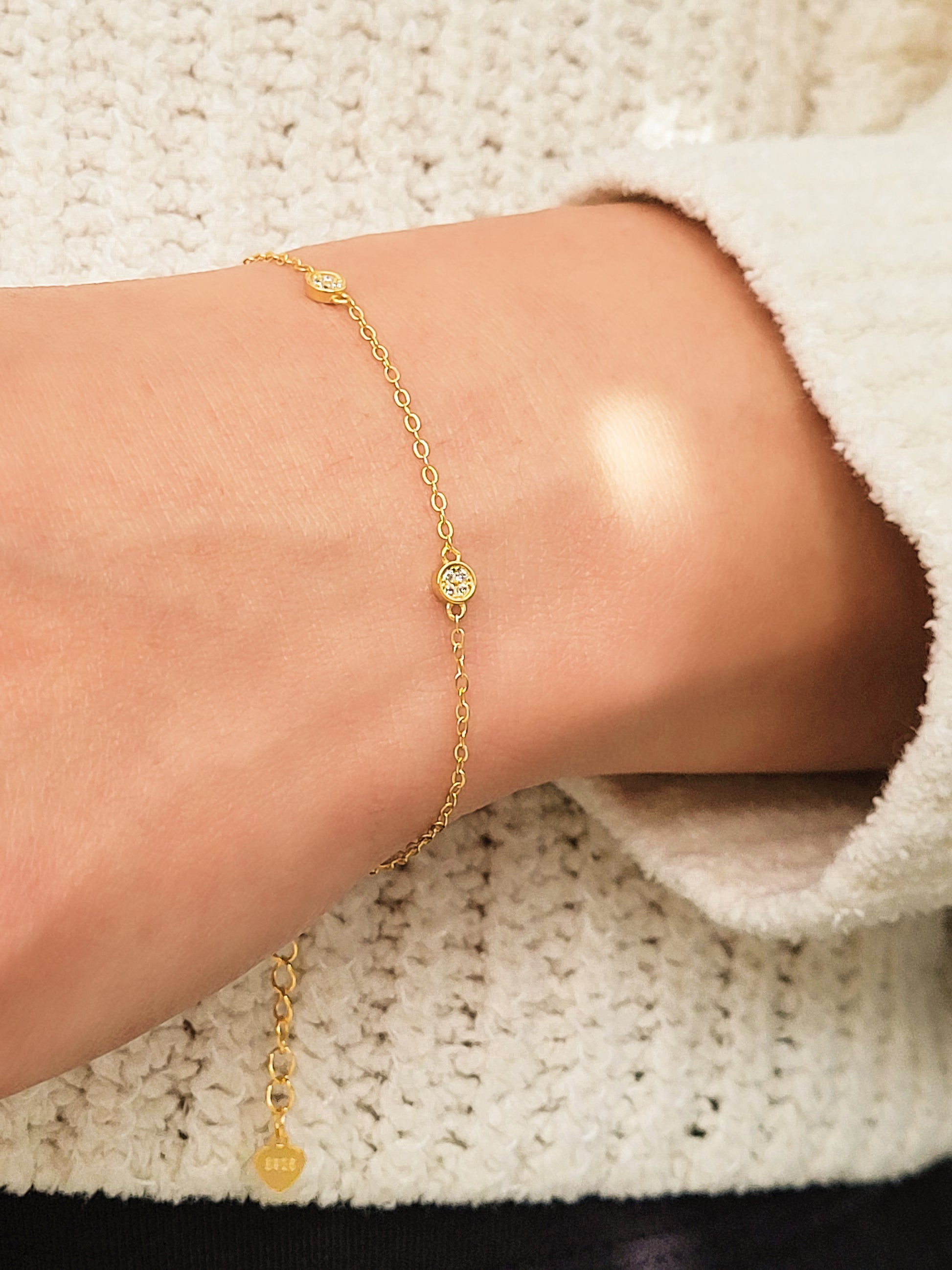 A stylish gold circle bracelet on a wrist, showcasing a minimalist design ideal for layering with other jewellery