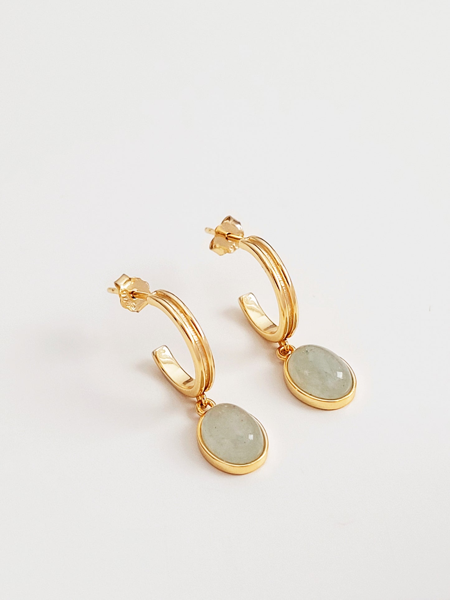 Luxurious gold hoop earrings featuring exquisite green aventurine stones, a perfect blend of elegance and natural charm.