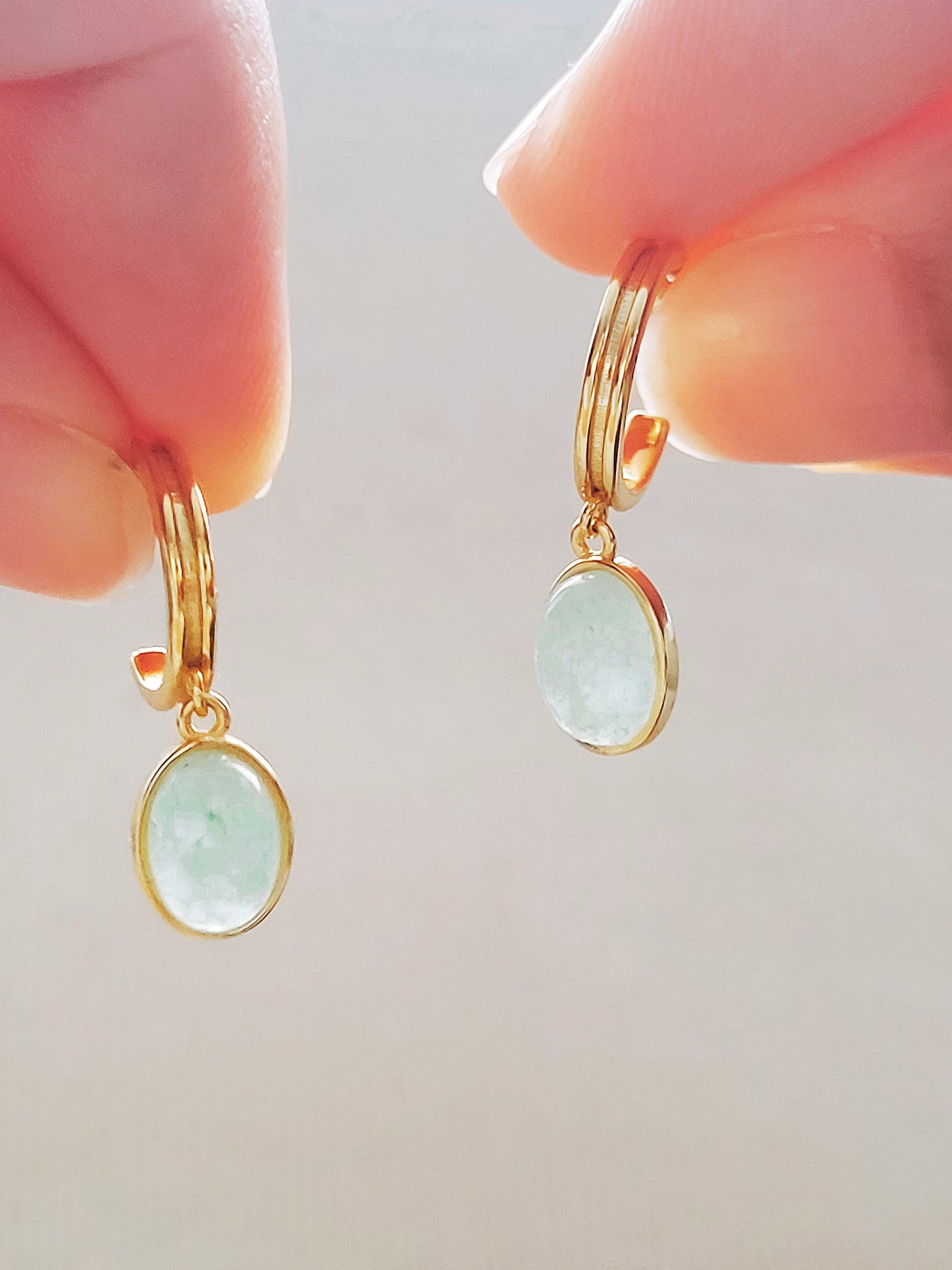 Stunning gold plated hoop earrings embellished with vibrant green aventurine gemstone, showcasing a refined and opulent aesthetic.