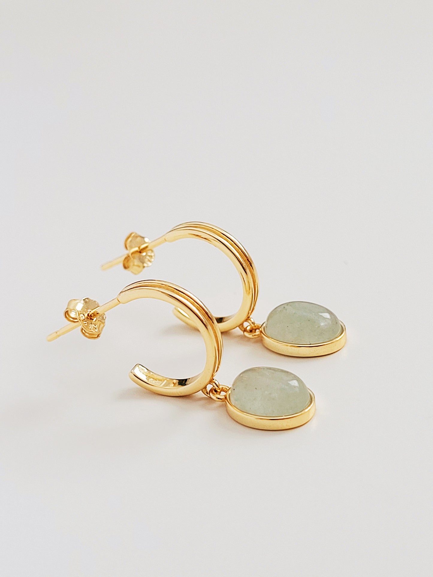 Elegant gold hoop earrings featuring green aventurine stones, perfect for adding a pop of color to any outfit.