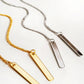 2 pairs of long bar threader earrings in gold and silver displayed on a white surface.