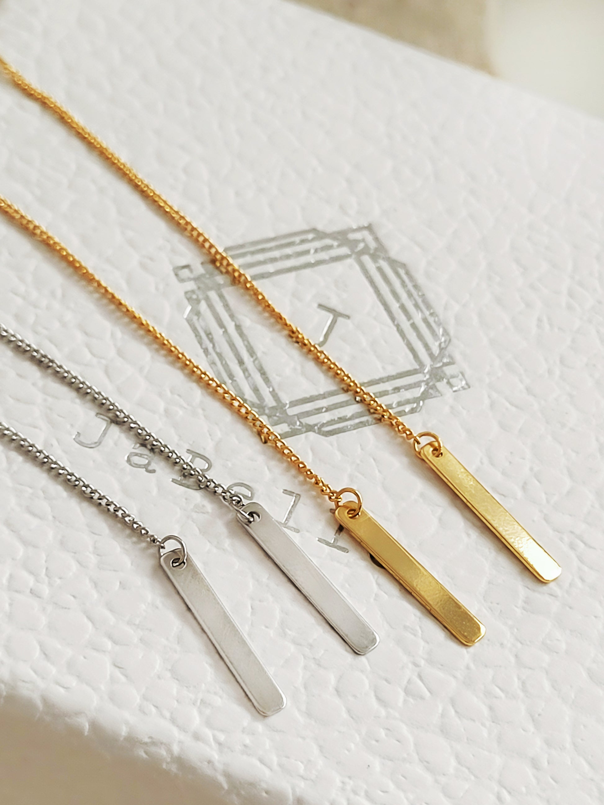 The long bar dangle threader earrings on JaBelle Jewellery box.