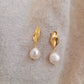 Elegant freshwater pearl dangle earring in gold, highlighting a modern, minimalistic design.