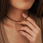 A close-up of a woman wearing a delicate 2mm black spinel beaded choker necklace featuring a center accent cluster of organic, textured 22k gold vermeil nuggets.