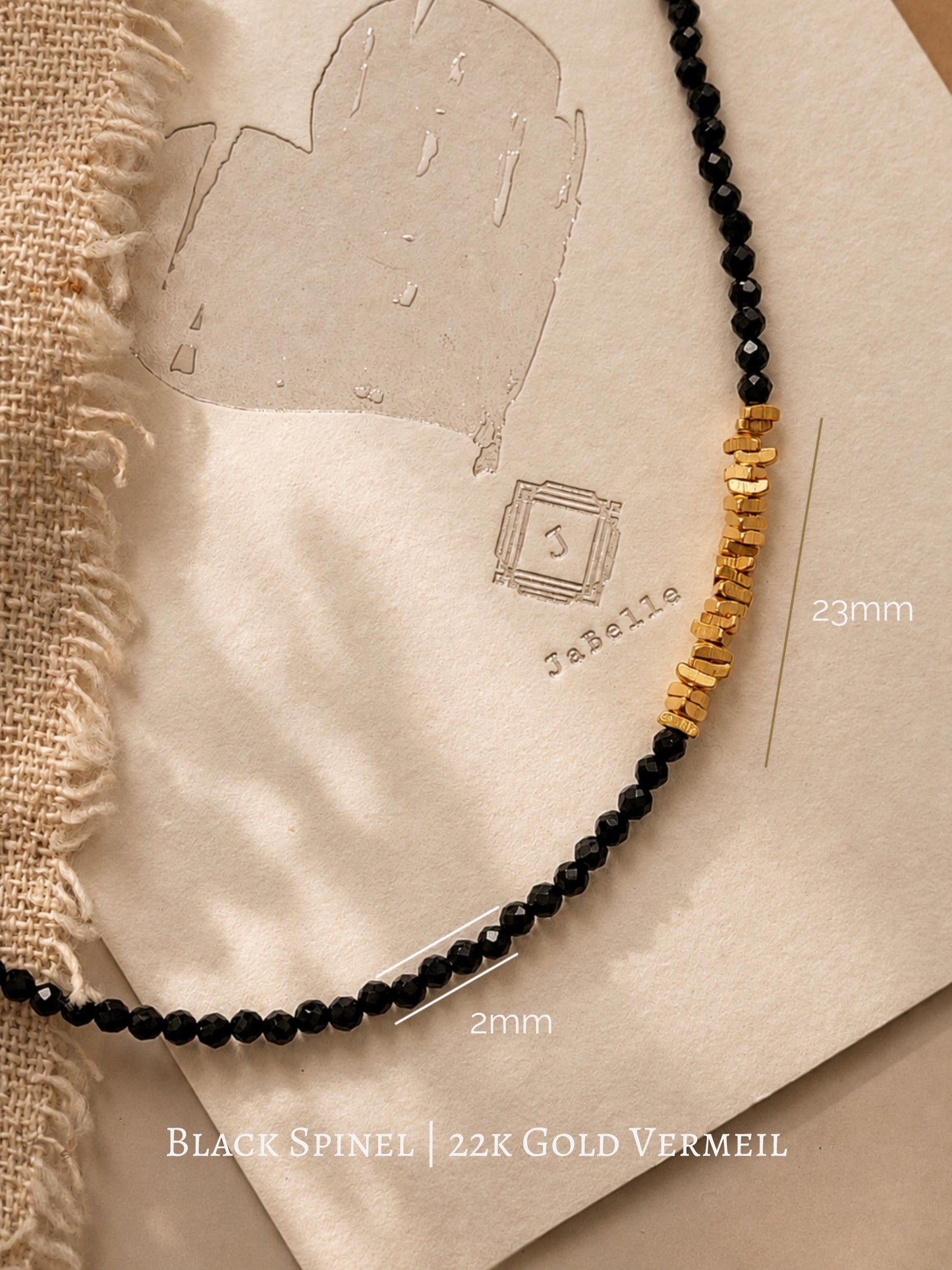Detailed view of a handmade black spinel gemstone choker necklace with a 23mm section of faceted, organic 22k gold vermeil nugget beads over 925 sterling silver.