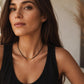 A close-up of a woman wearing a delicate 2mm black spinel beaded choker necklace featuring a center accent cluster of organic, textured 22k gold vermeil nuggets. Timeless elegant style, perfect anniversary gift for her.