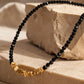 Detailed view of a handmade black spinel gemstone choker necklace with a 23mm section of faceted, organic 22k gold vermeil nugget beads over 925 sterling silver.