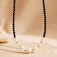 Black spinel pearl choker necklace with freshwater pearls and 18k gold plated sterling silver details, elegant handmade jewellery for weddings and gifting.