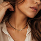 Handmade black spinel and freshwater pearl choker necklace with gold accents, worn as a minimalist bridal and everyday necklace.
