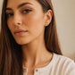 Dainty gold vermeil four-leaf clover stud earring worn on a model, featuring a textured finish for a minimalist everyday look.