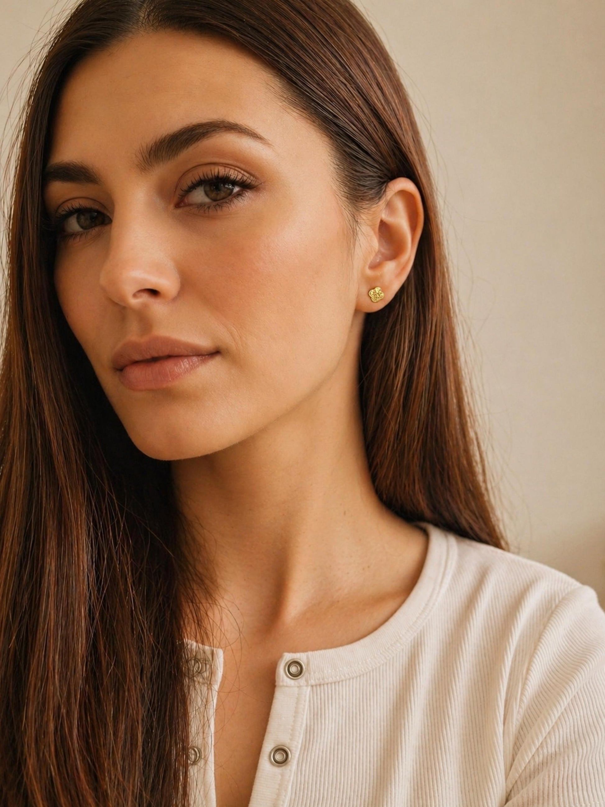 Dainty gold vermeil four-leaf clover stud earring worn on a model, featuring a textured finish for a minimalist everyday look.