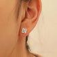 Dainty 925 sterling silver four-leaf clover stud earring worn on a model, featuring a textured finish for a minimalist everyday look.
