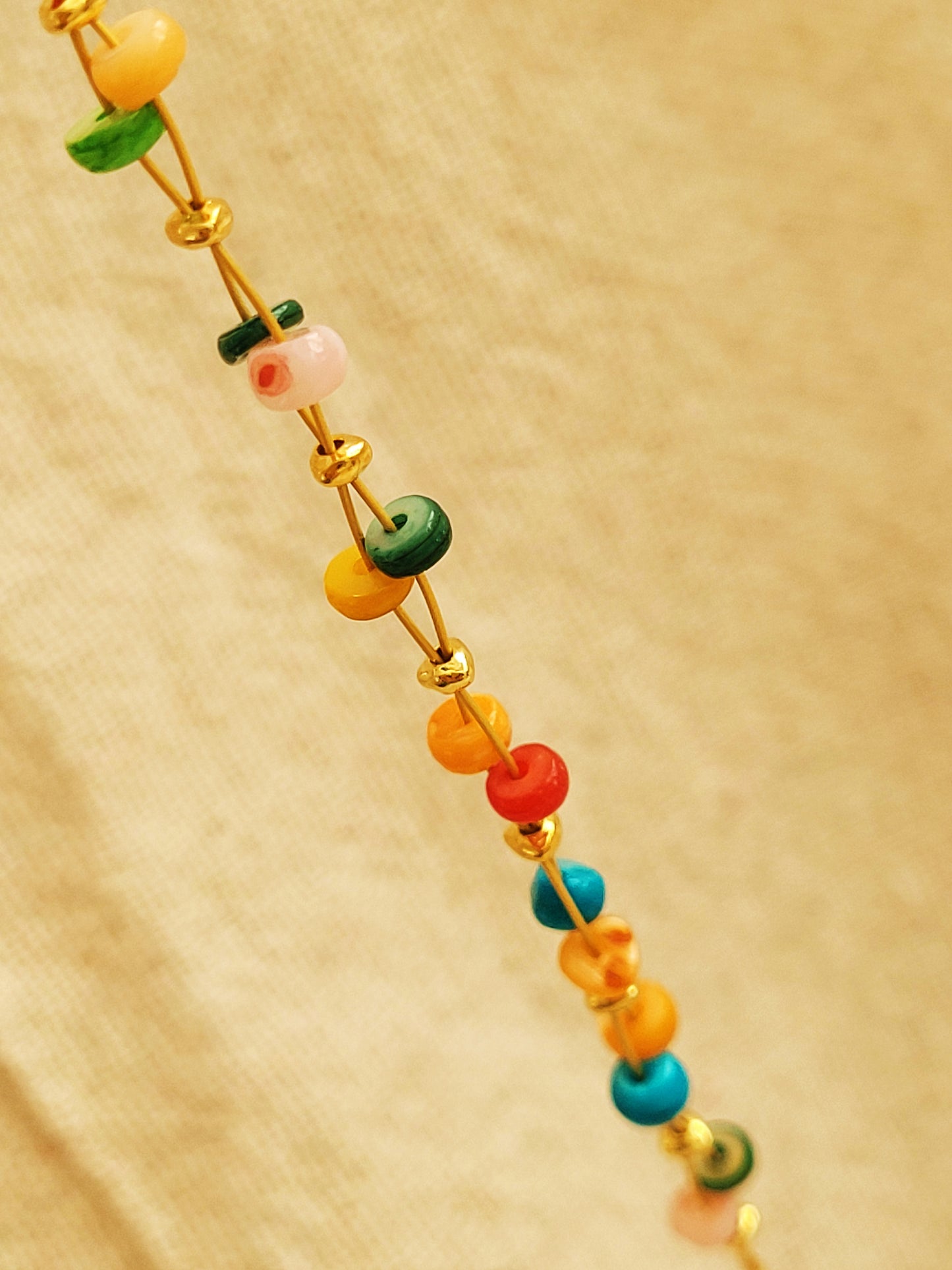 Close up of the colorful onyx gemstone beads and gold beads on a bracelet