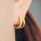 Chic double hoop earrings that catch the light beautifully, ideal for dressing up or down any look.