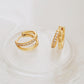 Stylish gold double hoop earrings with a sleek design, perfect for adding a touch of elegance to any outfit.