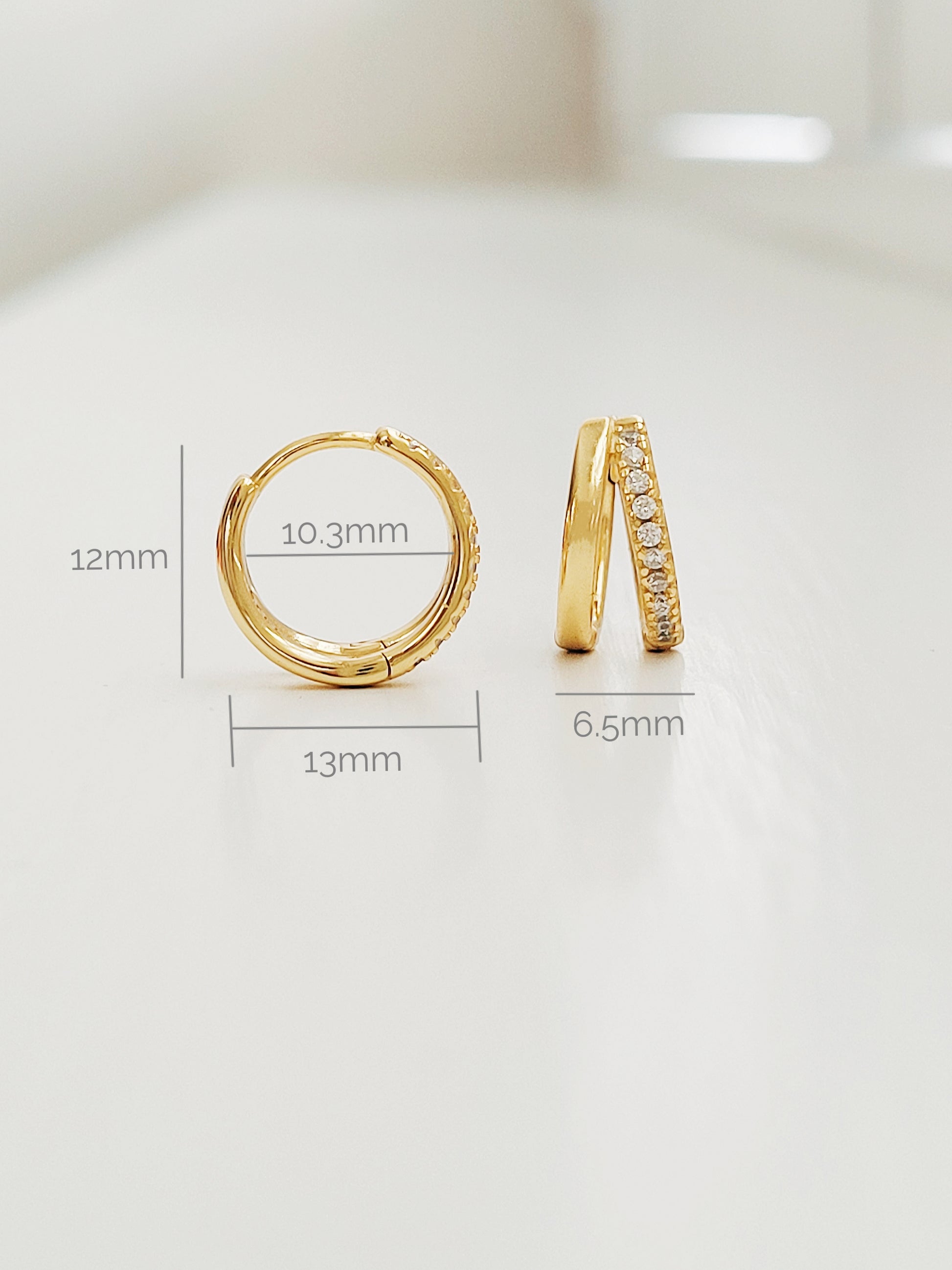 Stylish gold double hoop earrings with a sleek design, perfect for adding a touch of elegance to any outfit.