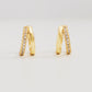 Elegant gold double huggie hoop earrings adorned with sparkling diamond-styled cubic zirconia, perfect for adding a touch of glamour.