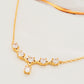 Close-up of a gold crown necklace with sparkling crystals, perfect for brides and special occasions.