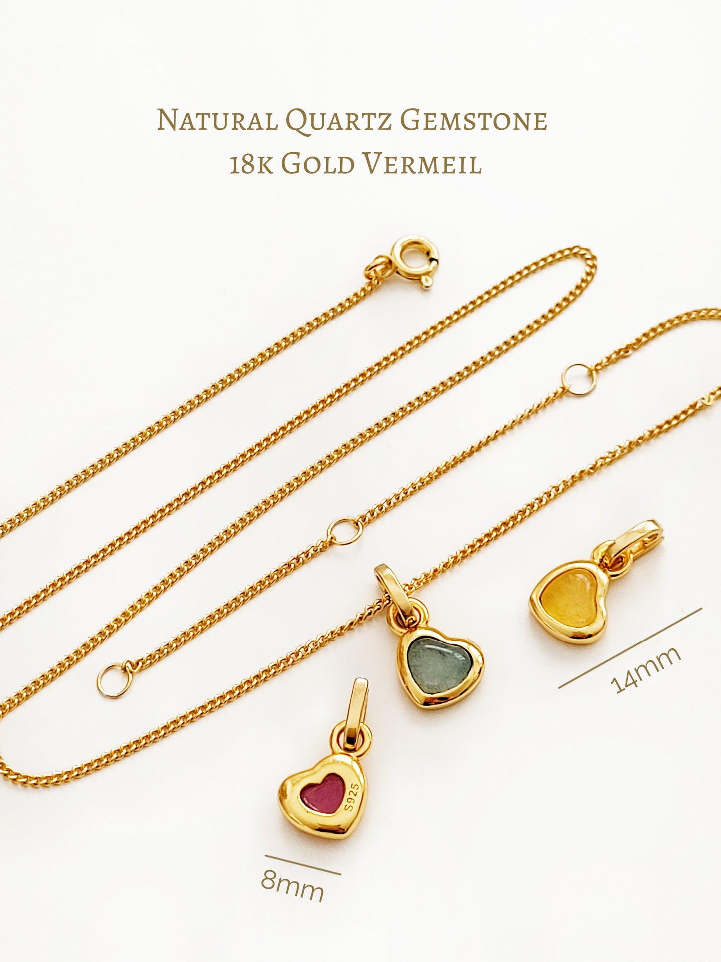 Gold necklace with heart-shaped pendants featuring natural quartz gemstones on a white background.