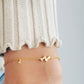 A stylish cute bow bracelet featuring two elegant bows intertwined, perfect for adding a touch of charm to any outfit.