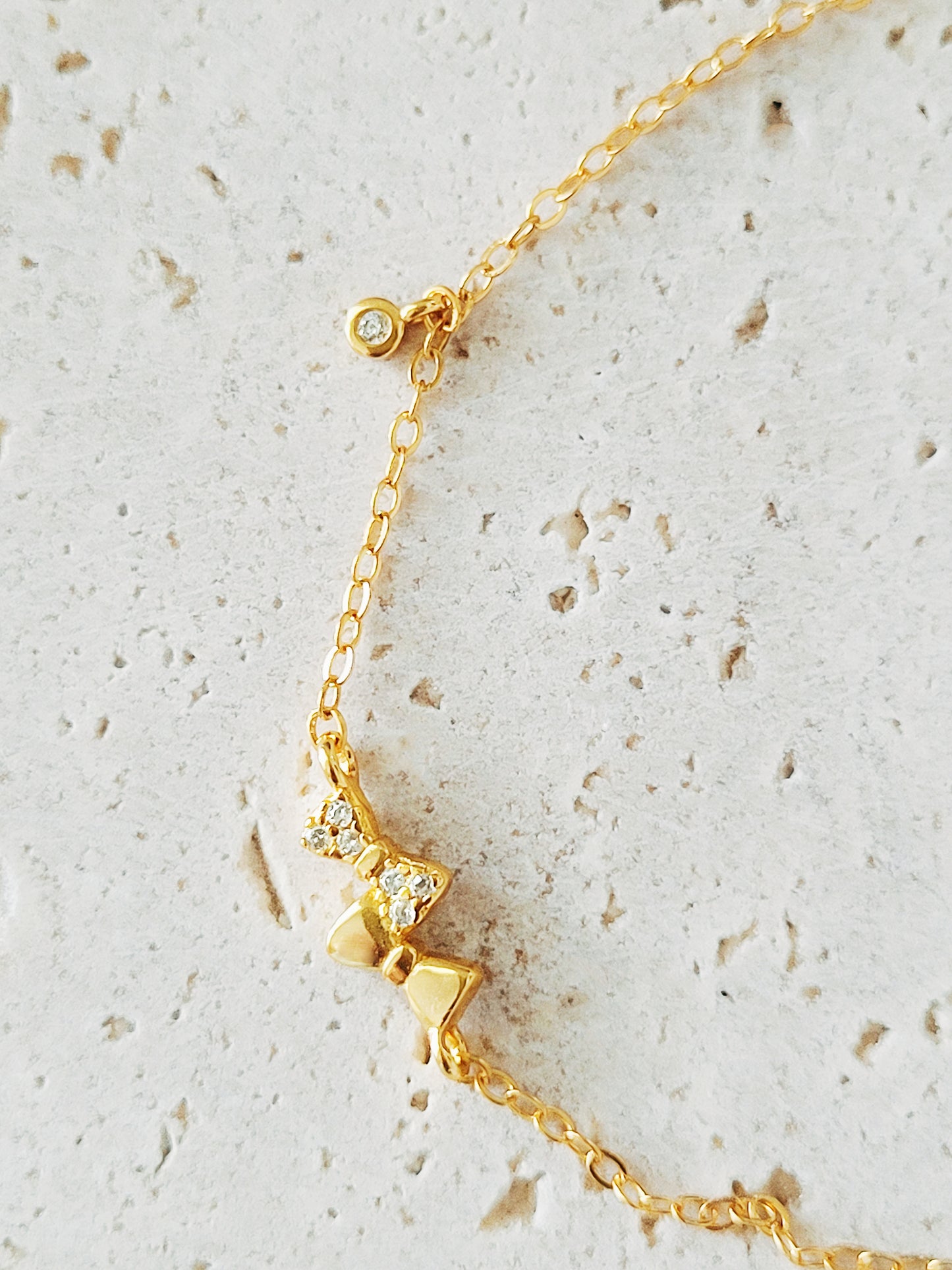 A charming bracelet adorned with a delicate bow, showcasing a playful yet elegant design suitable for any occasion.