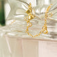 An elegant bracelet adorned with unique patterns, two cutie bows and a dangling charm. Ideal for enhancing any outfit with a touch of sophistication.