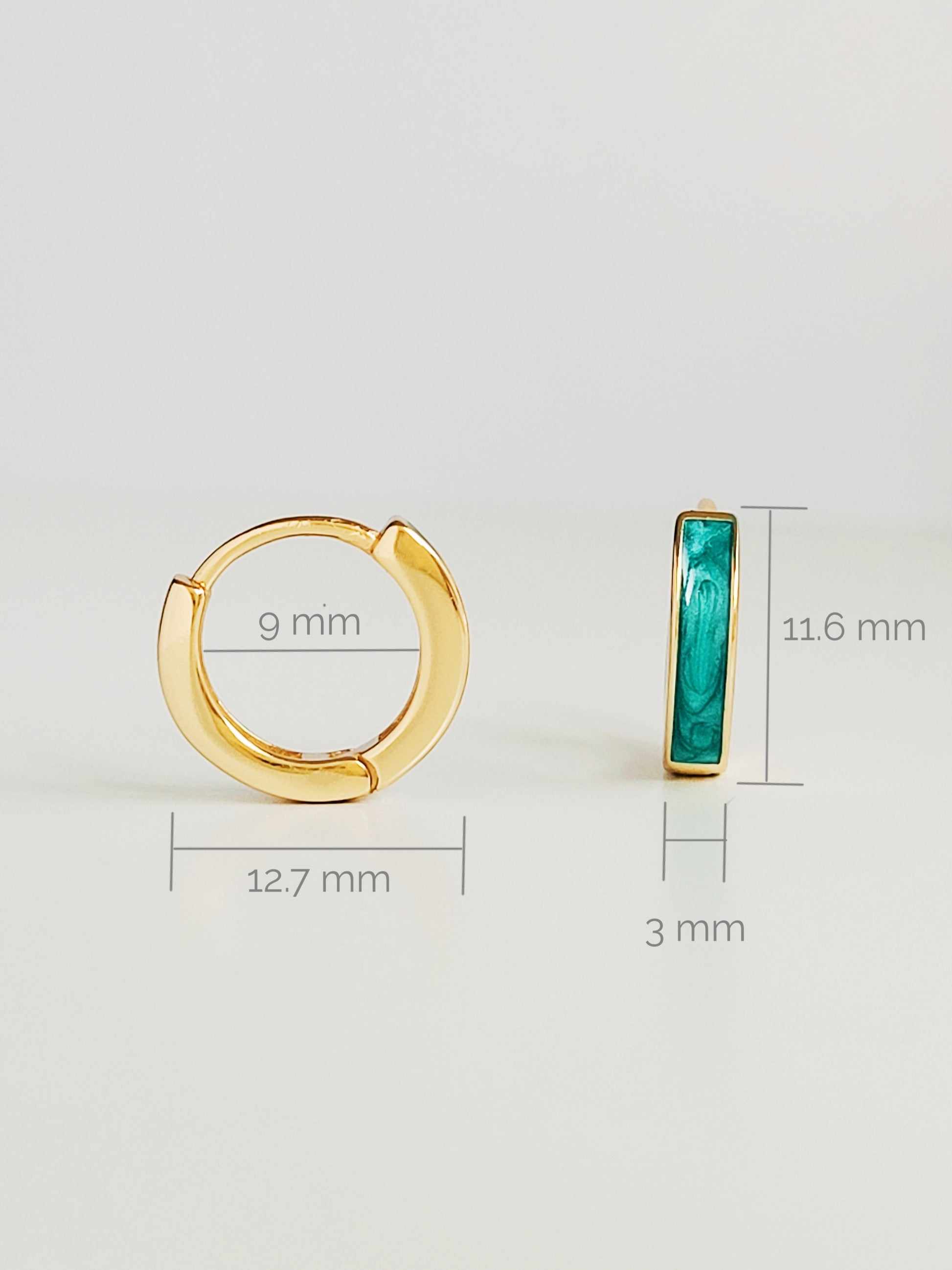 Beautiful gold and emerald green enamel huggie hoop earrings, showcasing a vibrant design that enhances any jewelry collection.