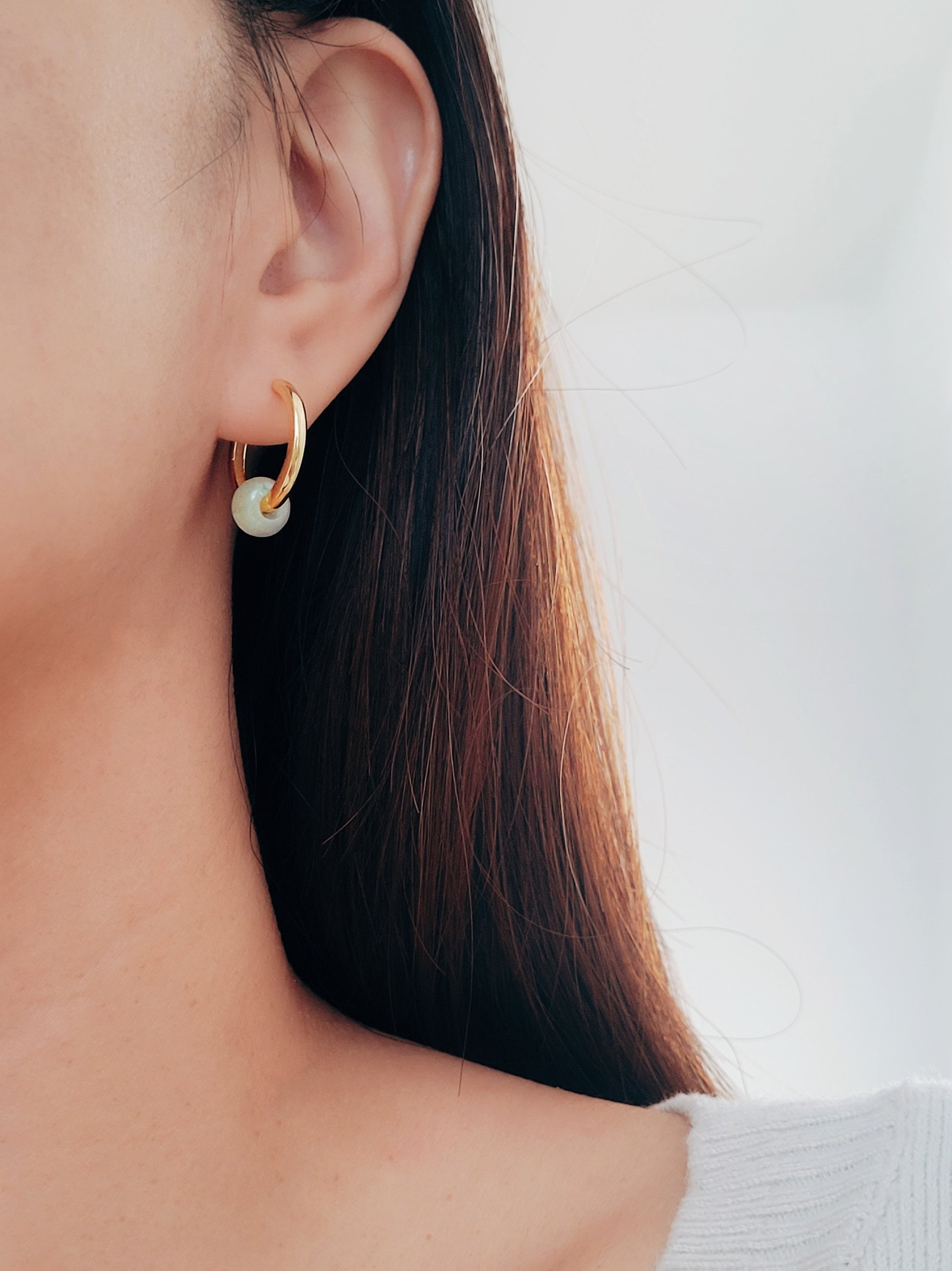 Chic jade hoop earrings with a pale green and gold finish jade gemstone, designed to complement a variety of fashion styles effortlessly.