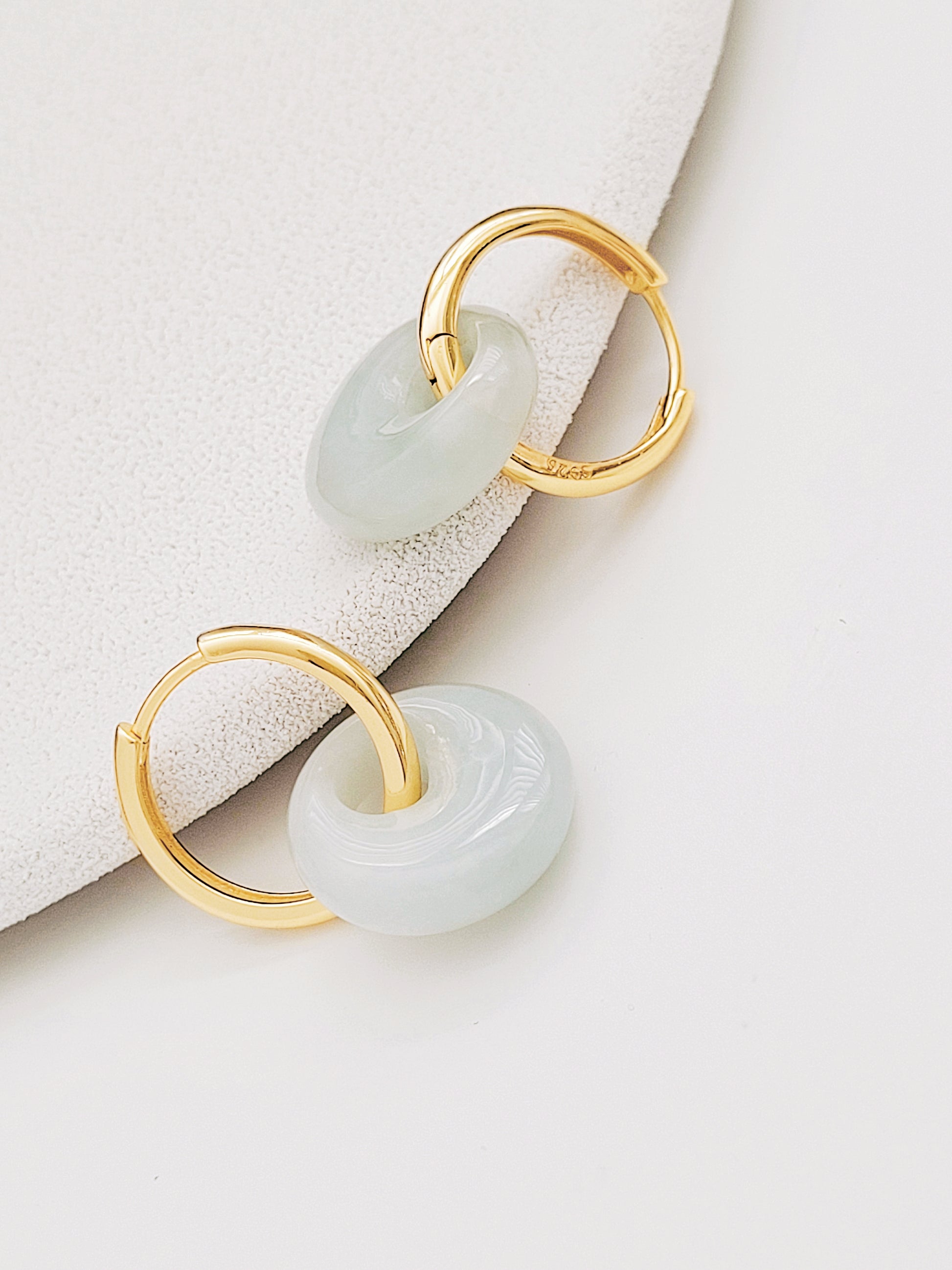 Jade drop earrings featuring smooth green jade stones on delicate gold hoops, great for gifting.