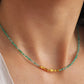 A woman wearing green onyx beaded gemstone choker necklace with gold vermeil accents, showing casing its fine jewellery details and elegance.