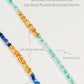 Close-up of kyanite beaded choker necklace with gold accents and handmade dainty gold choker with natural green onyx beads and gold nuggets.