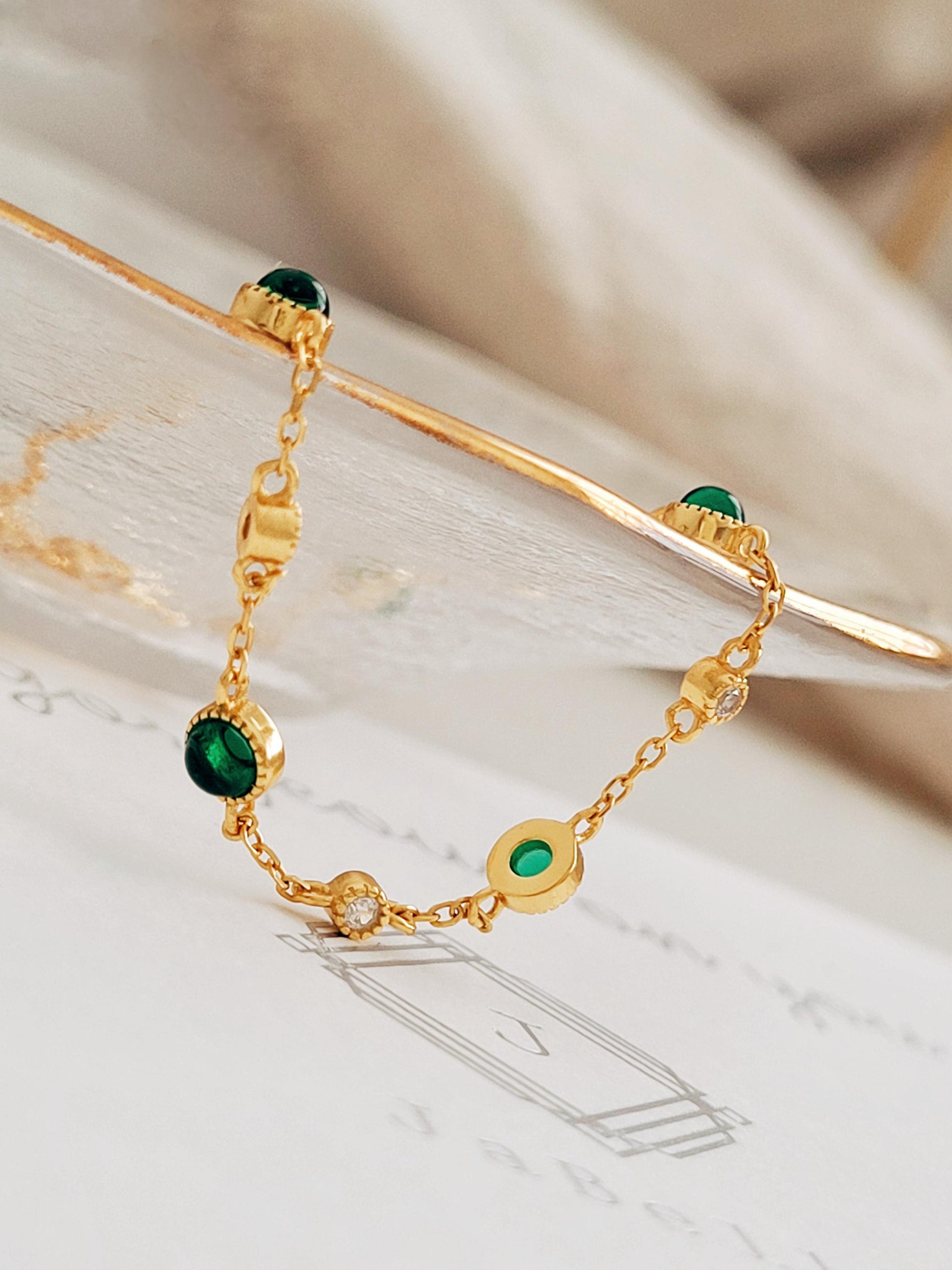 Close up of a green onyx bracelet on a jewellery card.