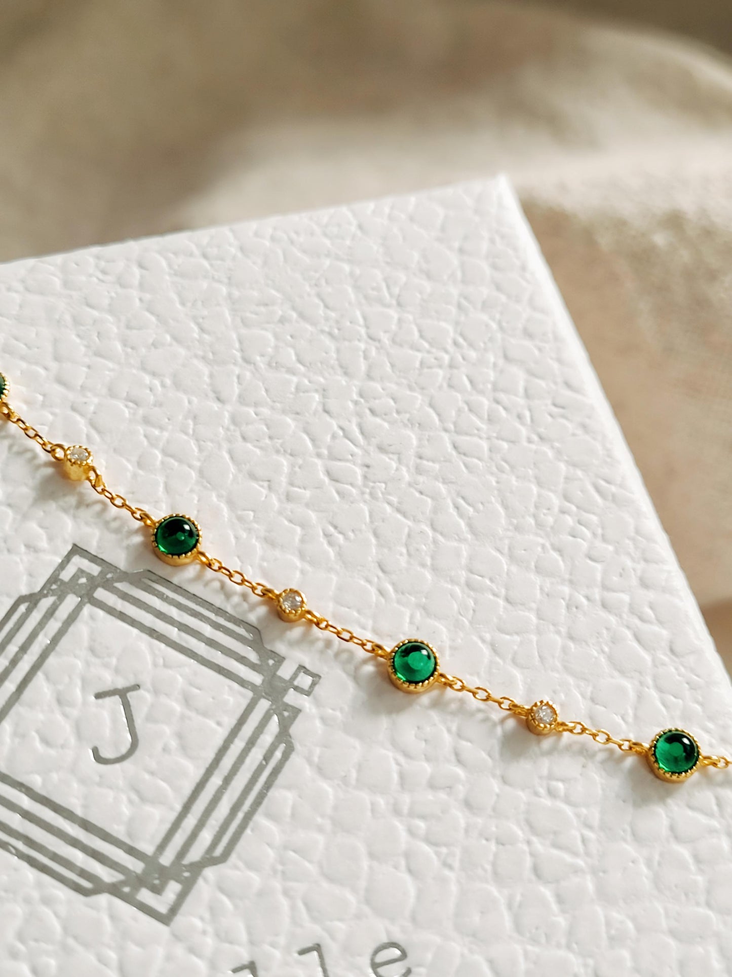 Clouse up on a dainty green onyx bracelet displayed on a jewellery box, perfect gift for her